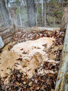 Bag of sawdust dumped on top of the compost pile.