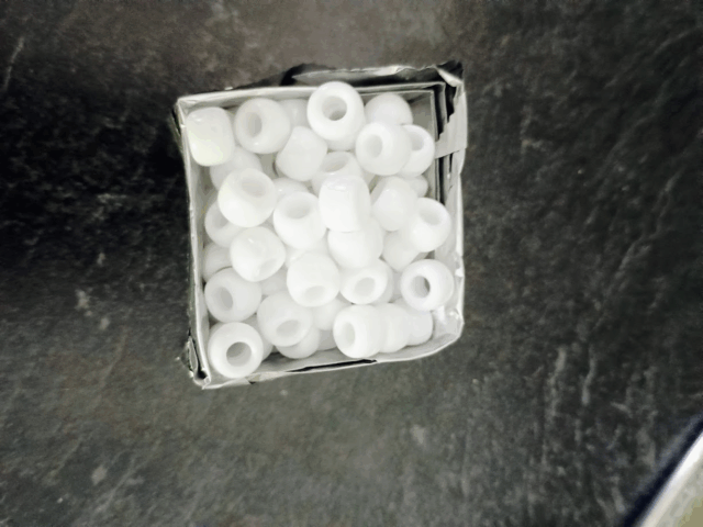 White beads inside foil cube